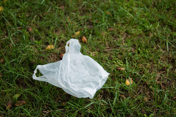 Used plastic bag on grass field