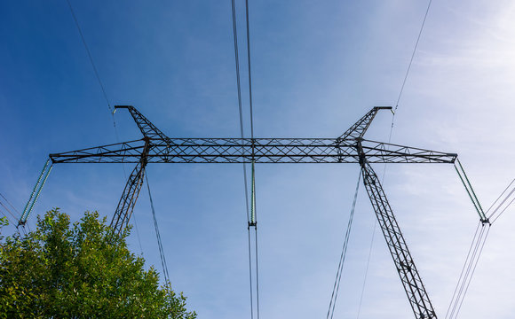 power line tower on a blue sky background. symbol of energy and power
