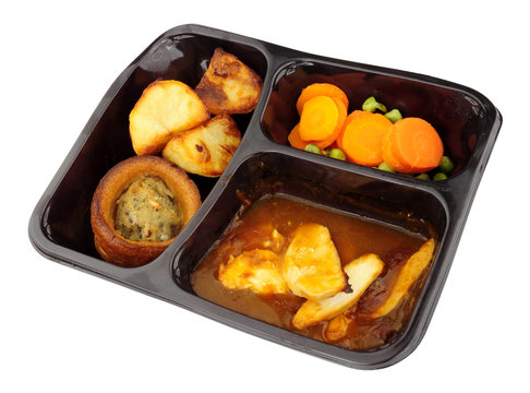 Roast chicken ready meal with Yorkshire pudding and vegetables isolated on a white background