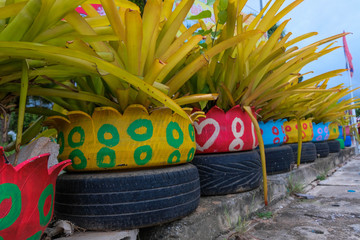 Colored green planters made from recycled tires.