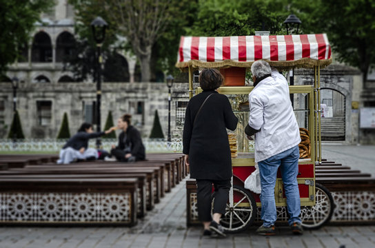 Street seller of fast food with bagle and simit on traditional turkish cart at Sultanahmet square