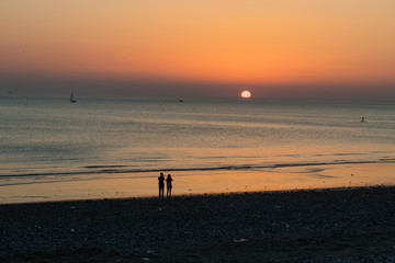 Sunset at the beach with romantic couple