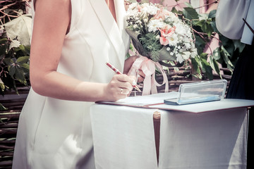 
wedding registration, the newlyweds groom and bride put a signature on the document
