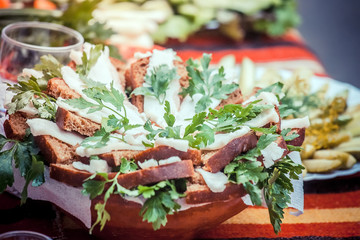 Traditional snack for Russian and Ukrainian people on the holidays. A sandwich with bacon, garlic and parsley under the glass of genuine Russian vodka 