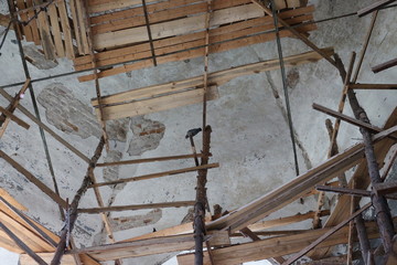ancient stone Church in the scaffolding for restoration