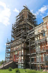 ancient stone Church in the scaffolding for restoration