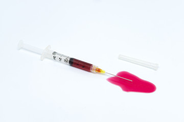Flat syringe with red blood inside