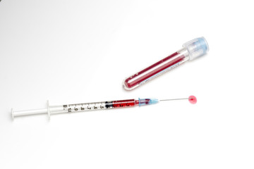 Fototapeta premium the 'BLOOD' concept of blood samples in the test tube, the droplets of the injection tip end