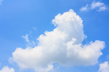 Naklejka na ściany i meble Fluffy cloud against blue sky background