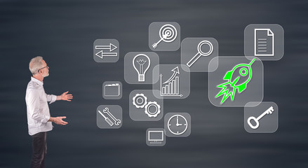 A start up concept explained by a businessman on a wall screen