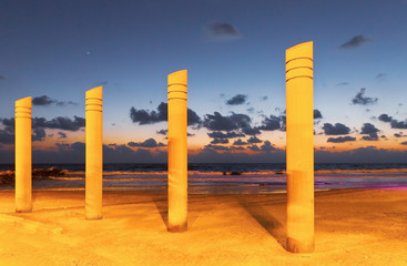 pillars on the beach in Haifa at sunset