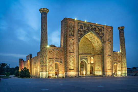 Ulugh Beg Madrasah located on famous Registan square at dusk in Samarkand, Uzbekistan