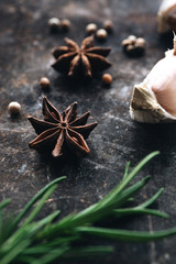 Rosemary, star anise on rustic background