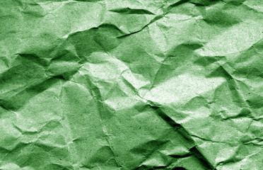 Old crumpled paper with wrinckles in green color.