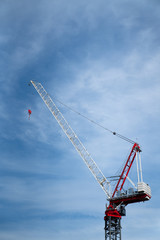 Red Crane Against Blue Sky at Construction Site - 215197339