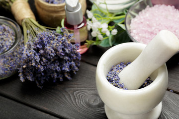 Fototapeta na wymiar Aromatic composition of lavender, herbs, cosmetics and salt on a dark table top