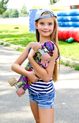 Adorable happy smiling  little girl child with skateboard outdoors © svetamart