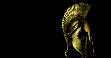 A wonderful golden Spartan helmet as part of the equipment of ancient greek soldiers. King Leonidas...
