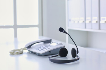 Call center and customer service help desk. VOIP headset on laptop computer keyboard