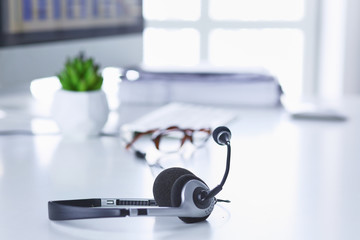 Call center and customer service help desk. VOIP headset on laptop computer keyboard