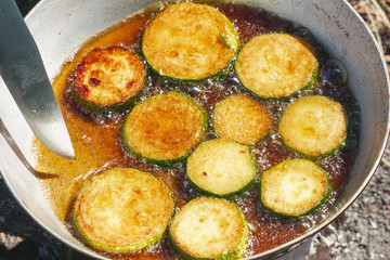 Fried zucchini in a frying pan.