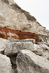 Quarry white stones near beach. Incredible rock formations. Backgrounds and textures. Vertical image.
