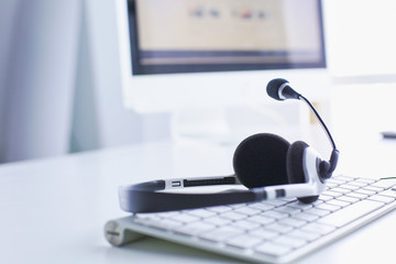 Call center and customer service help desk. VOIP headset on laptop computer keyboard