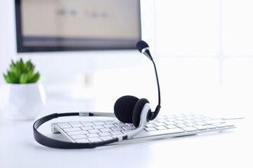 Call center and customer service help desk. VOIP headset on laptop computer keyboard