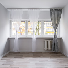 Empty room with window curtains