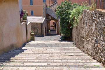Stone staircase descends into a small old courtyard