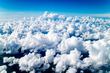 Beautiful contrasted cotton clouds in the sky from the plane