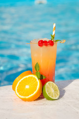 Tropical cocktail on a pool background