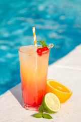 Tropical cocktail on a pool background