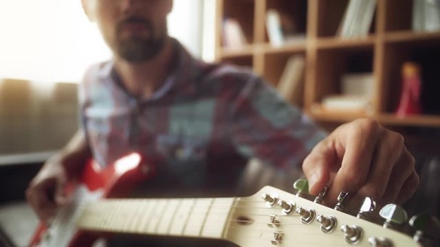 The guy plays the electric guitar