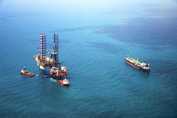 Oil rig in the gulf with oil tanker ship