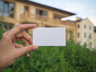 Business card on the background of suburban real estate.