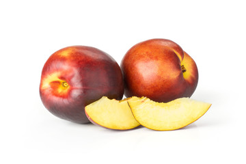 Fototapeta na wymiar Group of two whole two slices of ripe deep red nectarine set isolated on white