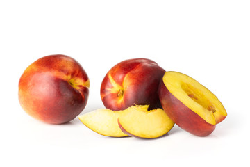 Group of two whole one half two slices of ripe deep red nectarine set isolated on white