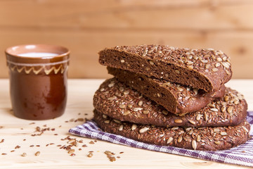 rye bread with a glass of milk on a wooden rustic background