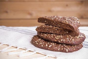 Rye bread with sunflower seeds and flax on a wooden table
