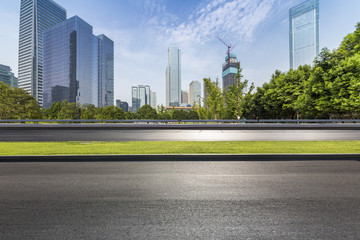 Obraz premium Panoramic skyline and modern business office buildings with empty road,empty concrete square floor
