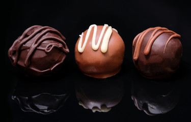 Chocolate candies on a black background