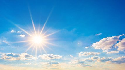 Naklejka na ściany i meble Hot summer or heat wave background, blue sky with glowing sun