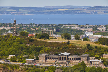 Naklejka premium View of Calton Hill from Holyrood Park with beautiful blue sky in Edinbourgh, Scotland, United Kingdom.