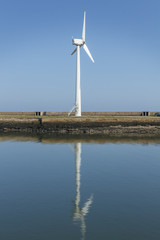 Windmill on a Harbour wall, generating electrisity