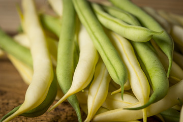 Fresh raw beans on a wooden background