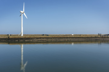 Windmill on a Harbour wall, generating electrisity