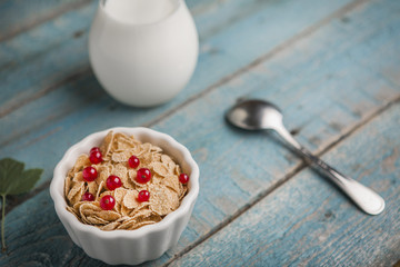 White bowl with corn cereals oatmeal flakes