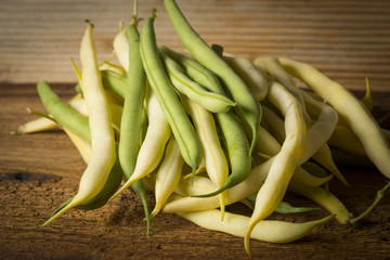 Fresh raw beans on a wooden background