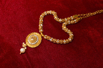 Artificial necklace on red background